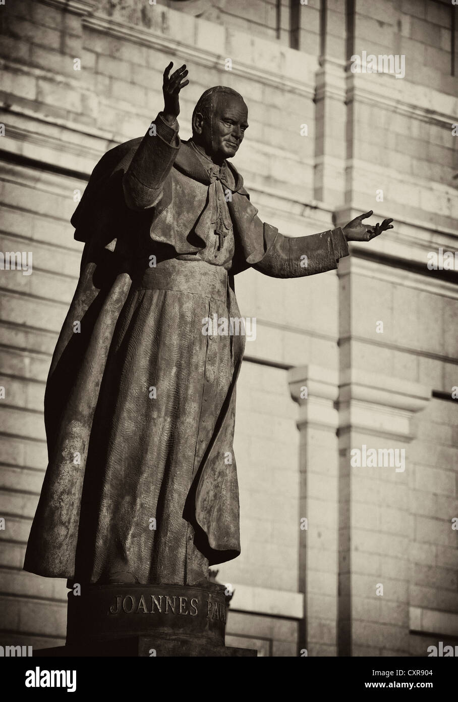 Statue of Pope John Paul II, monument, open arms, sepia, vignette, Catedral de Nuestra Señora de la Almudena cathedral, Santa Stock Photo