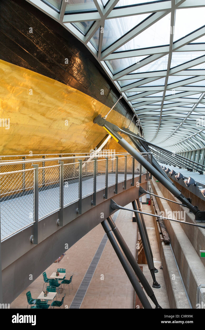 The Cutty Sark a restored tea clipper ship with golden hull in dry dock at Greenwich in London Stock Photo