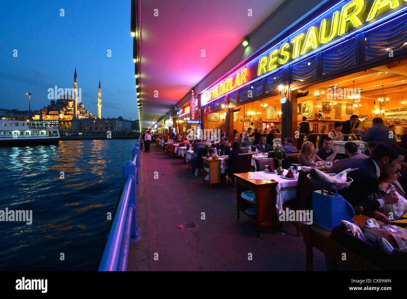 Restaurants beneath the Galata Bridge, Galata Koepruesue, Yeni Camii Mosque, night shot, Galata, Sirkeci, Istanbul, Turkey Stock Photo