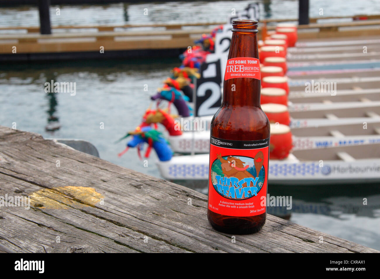Bottle of beer and dragon boats in Victoria BC Stock Photo Alamy