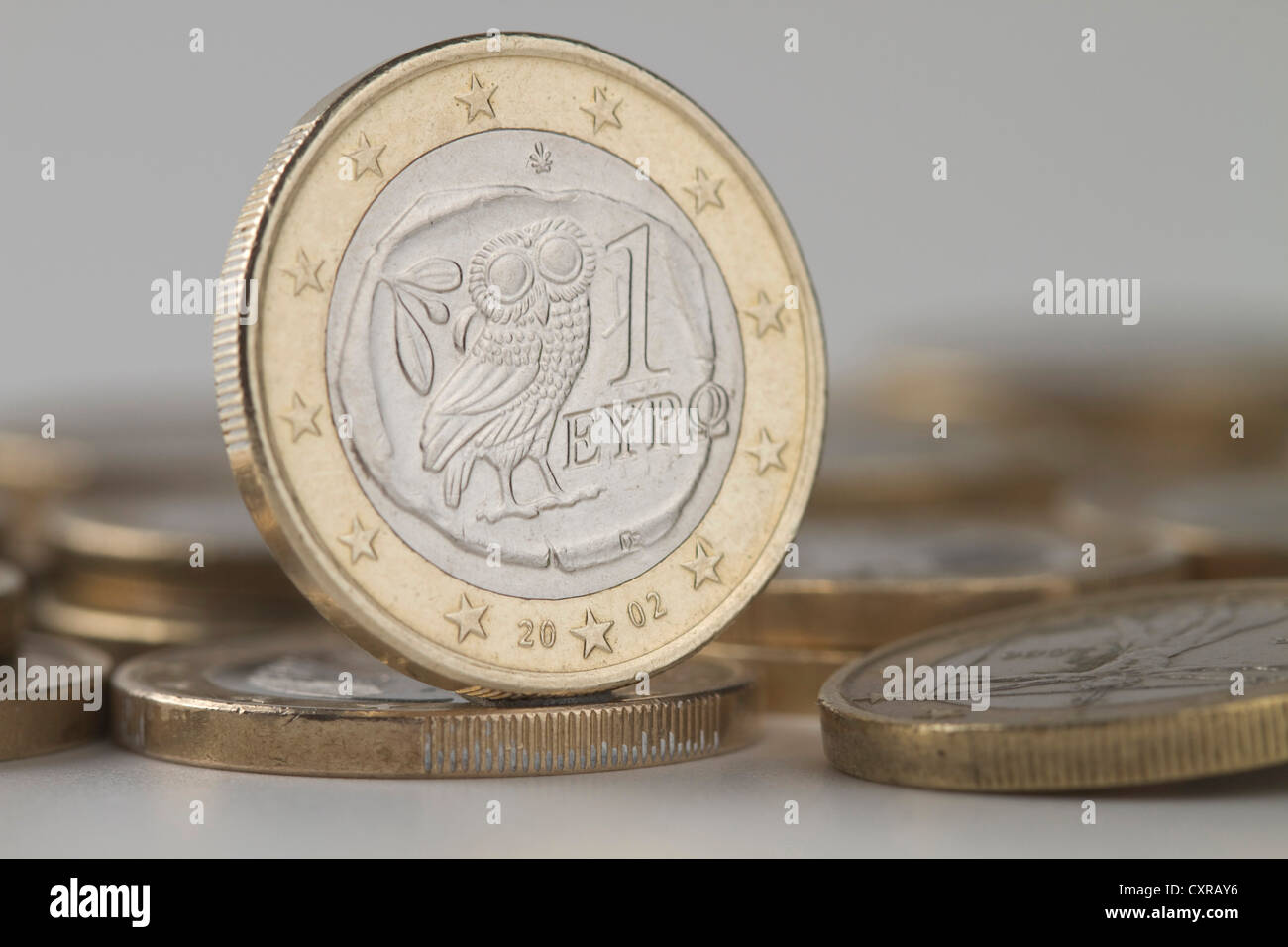 A Greek one-euro-coin on a pile of euro-coins, symbolic image for the Greek debt crisis Stock Photo