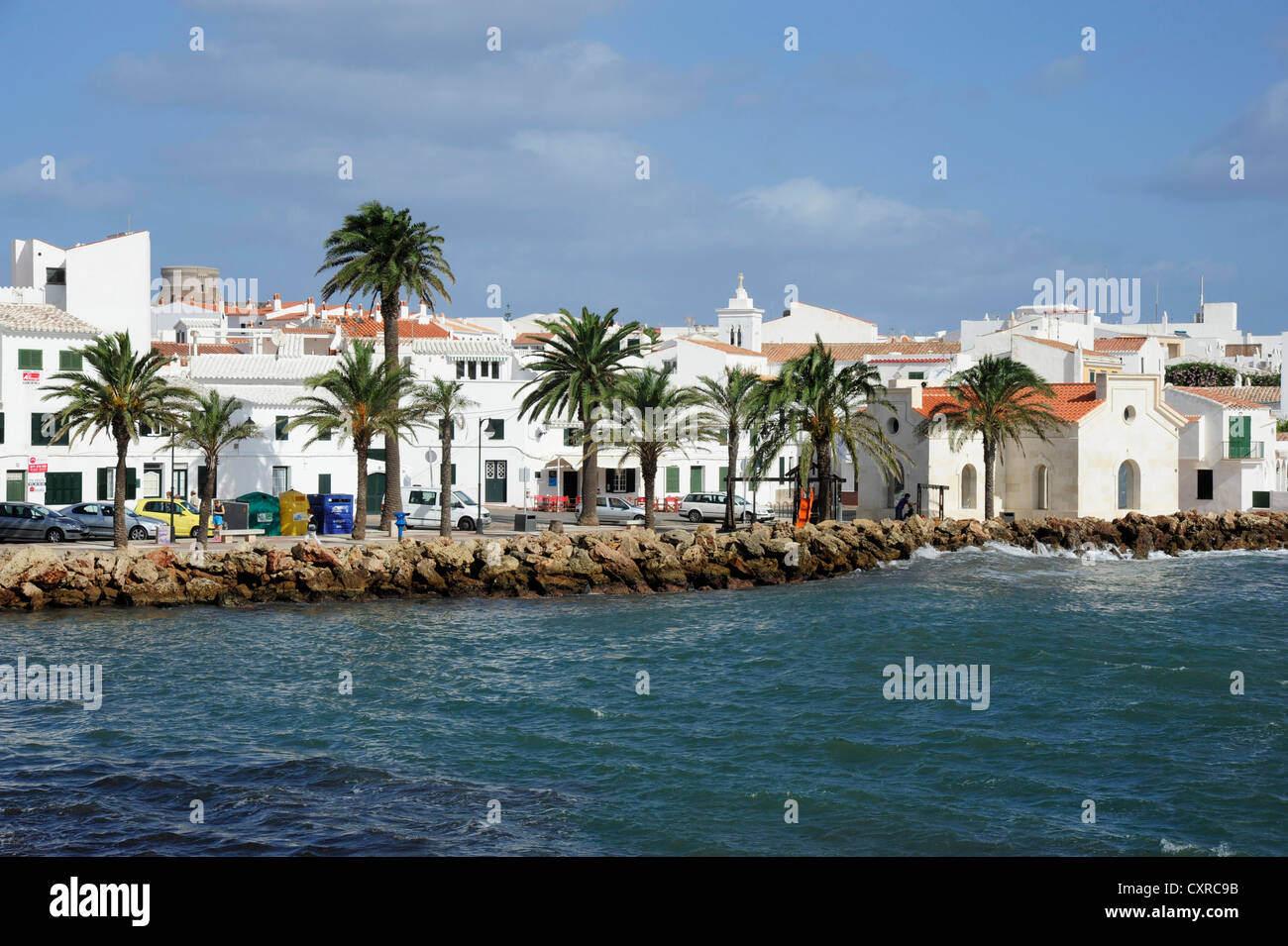 White houses and palm trees in the bay Badia de Fornells, Fornells ...