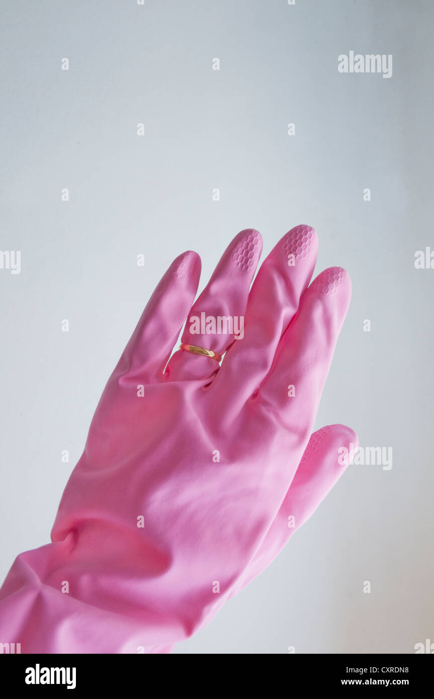 Woman's hand wearing washing glove and a ring. Stock Photo