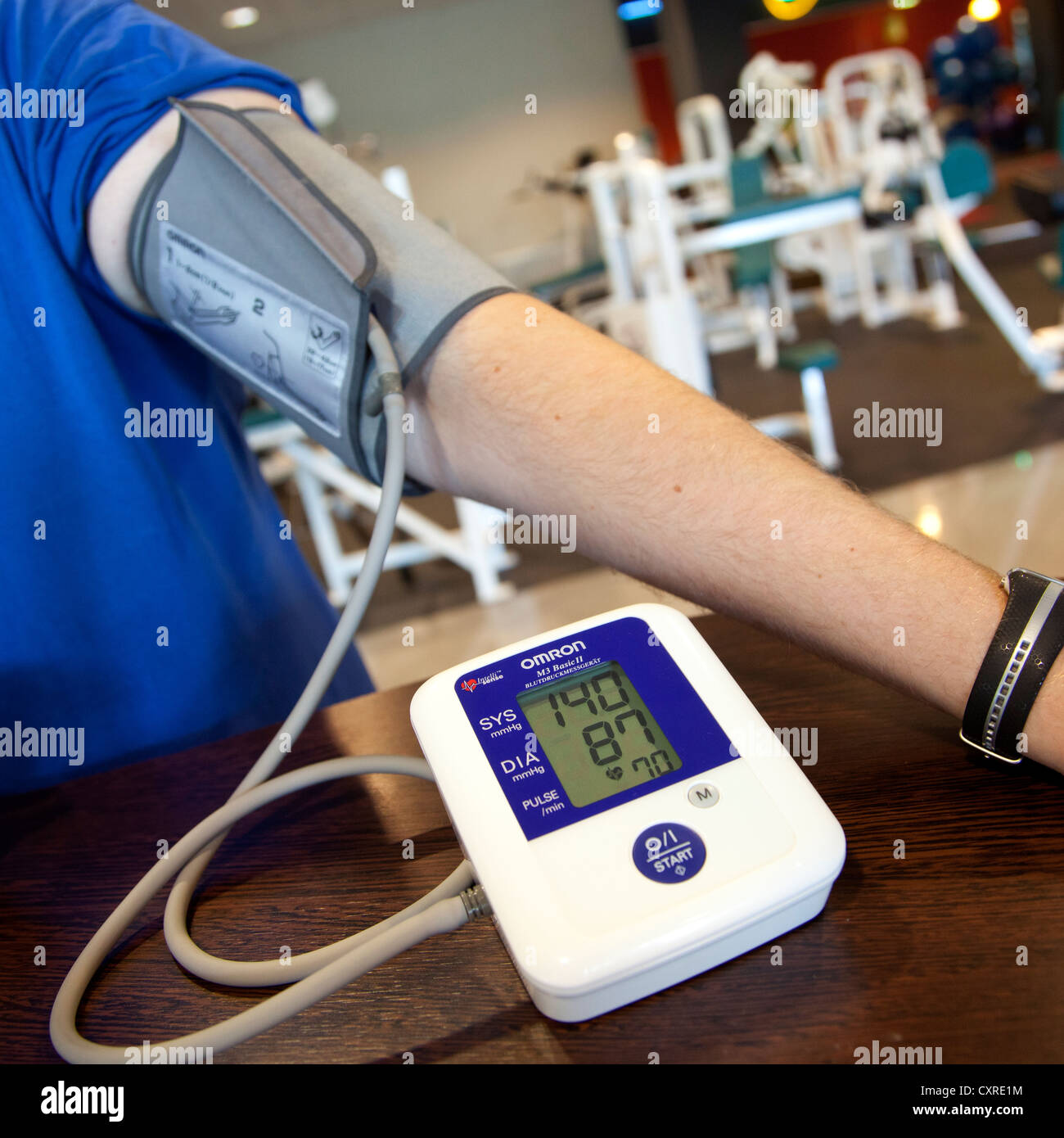 Heart rate monitor, blood pressure measurement, prior to a workout at the fitness centre, Regensburg, Bavaria, Germany, Europe Stock Photo