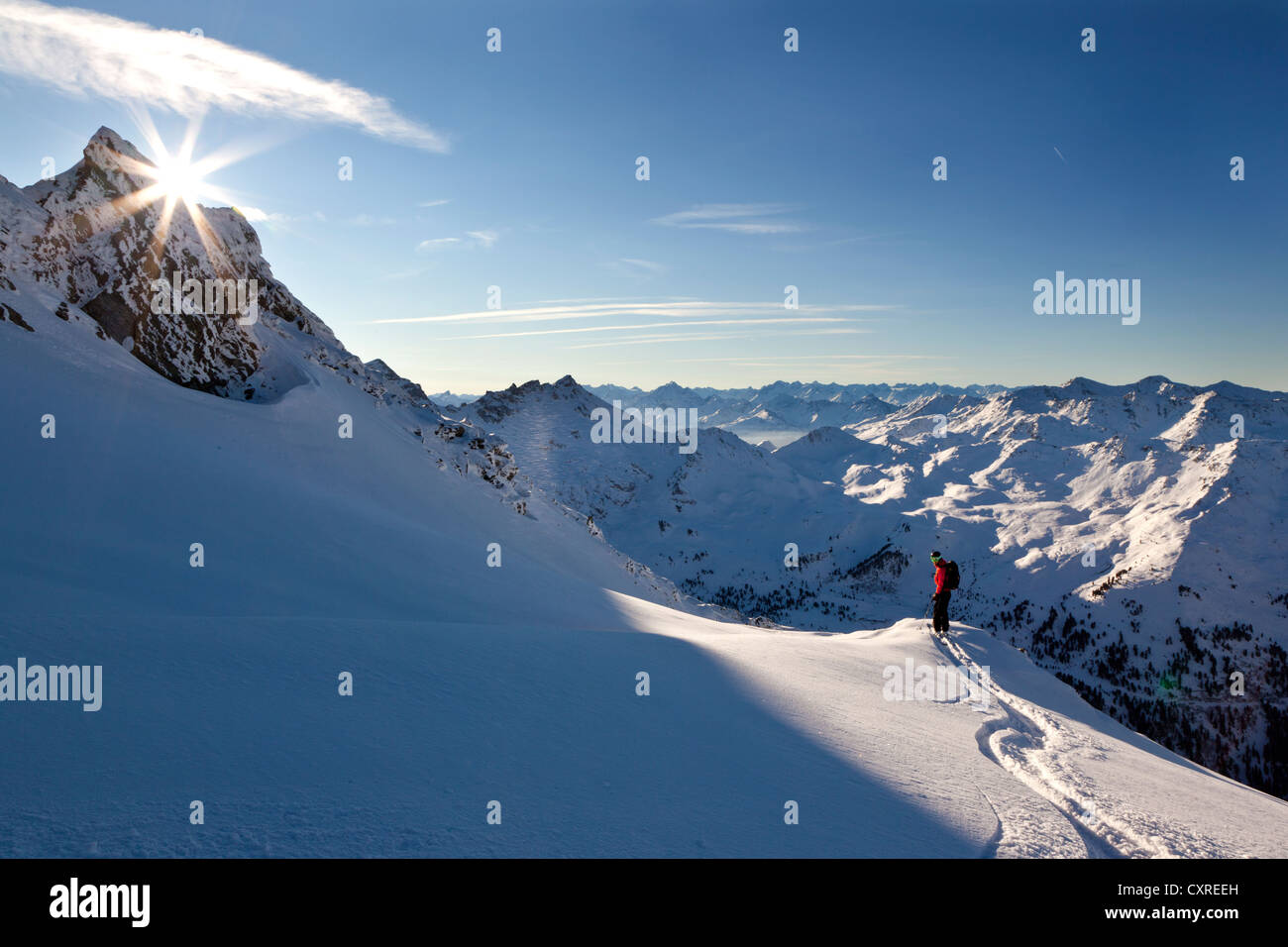 Skier downhill skiing on Torspitze mountain, sun hidden behind a mountain peak, Tux Alps, northern Tyrol, Tyrol, Austria, Europe Stock Photo