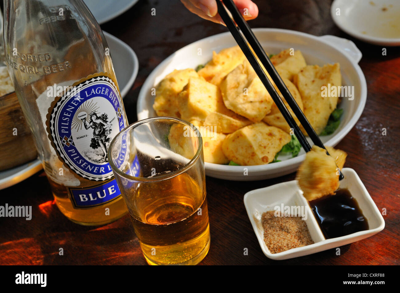 Blue Girl beer with fish at the restaurant of the Tai O Fishing Village, Lantau Island, Hong Kong, China, Asia Stock Photo