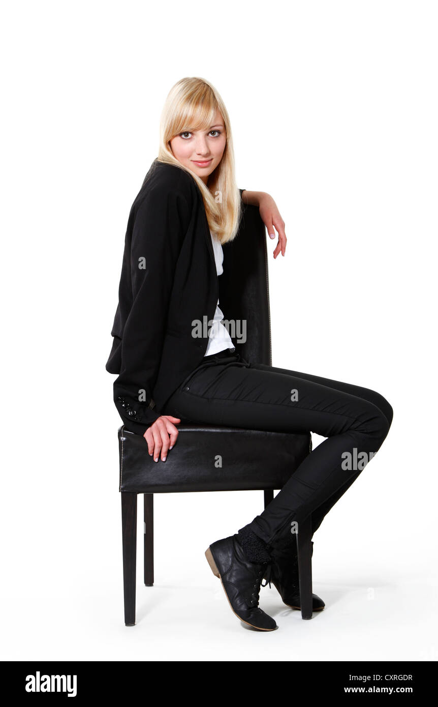 Young woman sitting on a chair Stock Photo