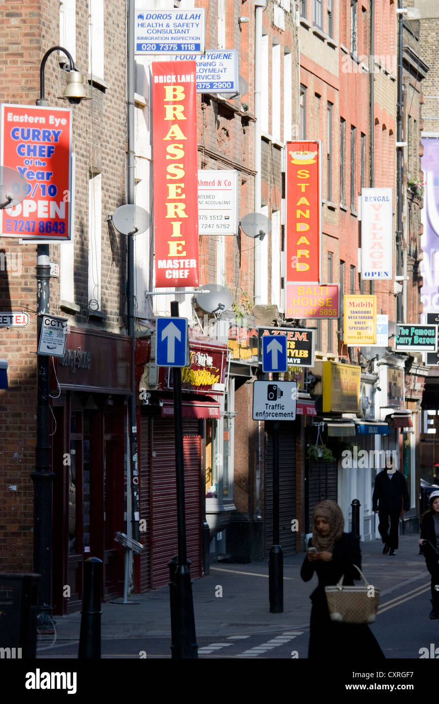 Indian curry restaurants line Brick Lane in London, UK—celebrated for authentic South Asian cuisine, vibrant atmosphere, and the area's rich cultural heritage as a cornerstone of the British Bangladeshi community in the East End Stock Photo