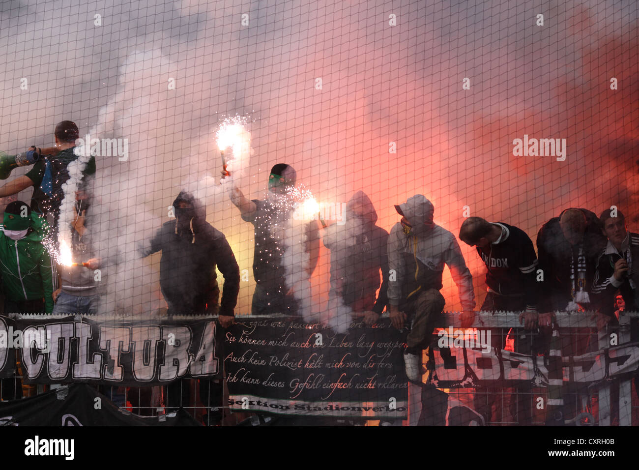 Fans of Borussia Moenchengladbach have ignited fireworks and flares during the match FSV Mainz 05 vs Borussia Moenchengladbach Stock Photo