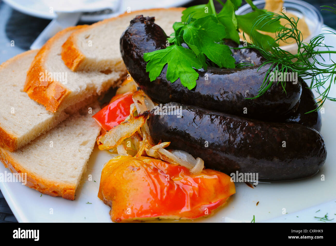 Black pudding and baked apple - traditional Polish food Stock Photo