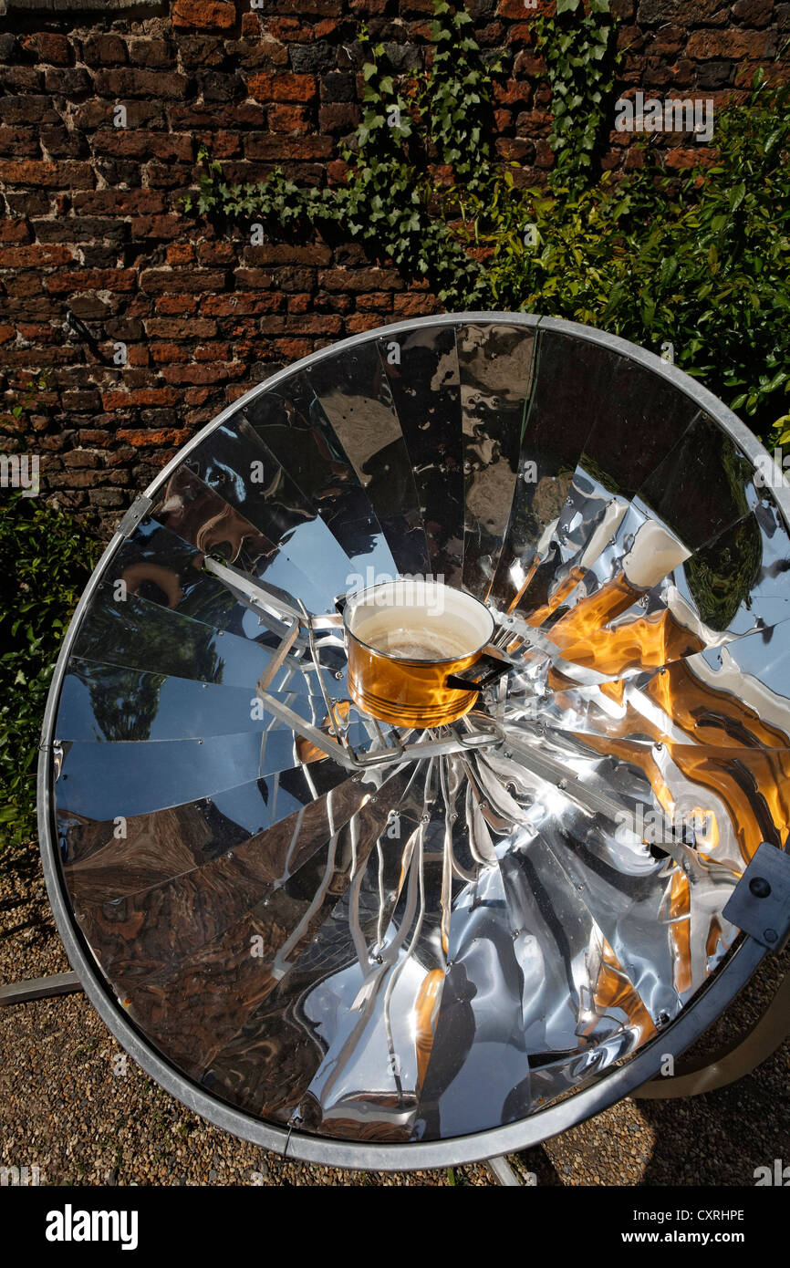 Solar cooker and energy saving stove of the ADES Organisation, pot is being heated by a parabolic mirror, North Rhine-Westphalia Stock Photo