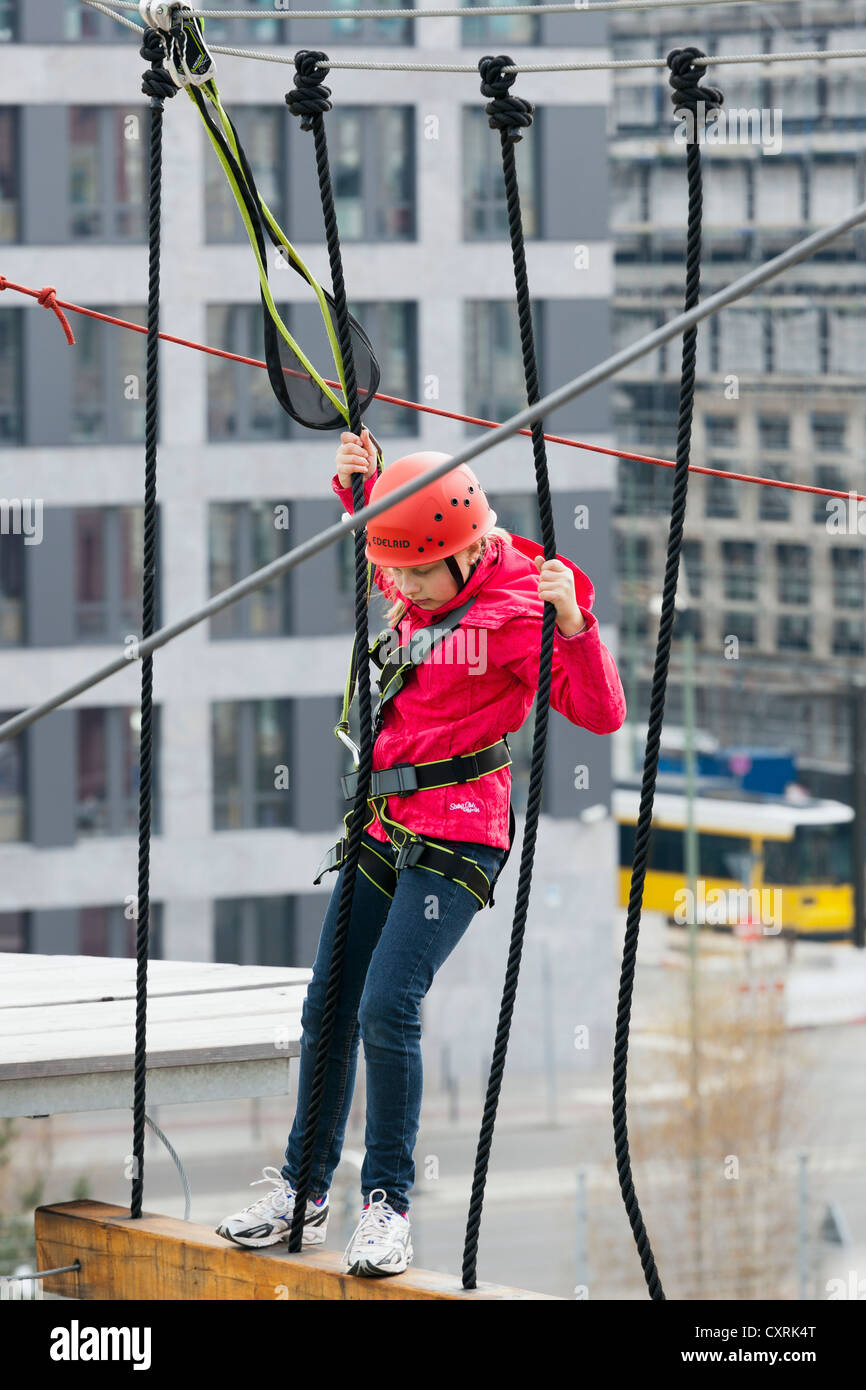 10yearold girl climbing in a high rope course, Berlin, Germany