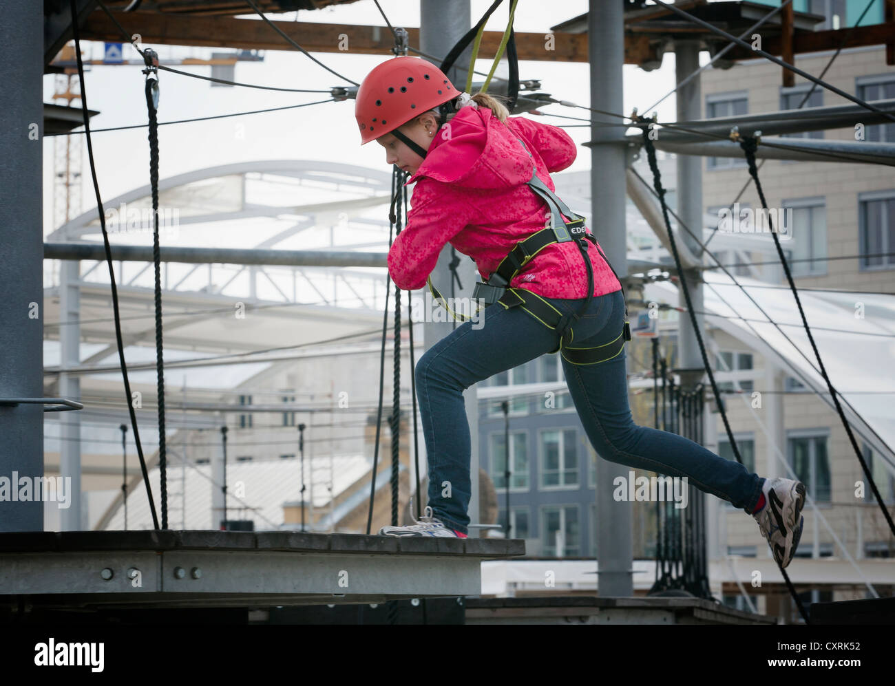 10yearold girl climbing in a high rope course, Berlin, Germany