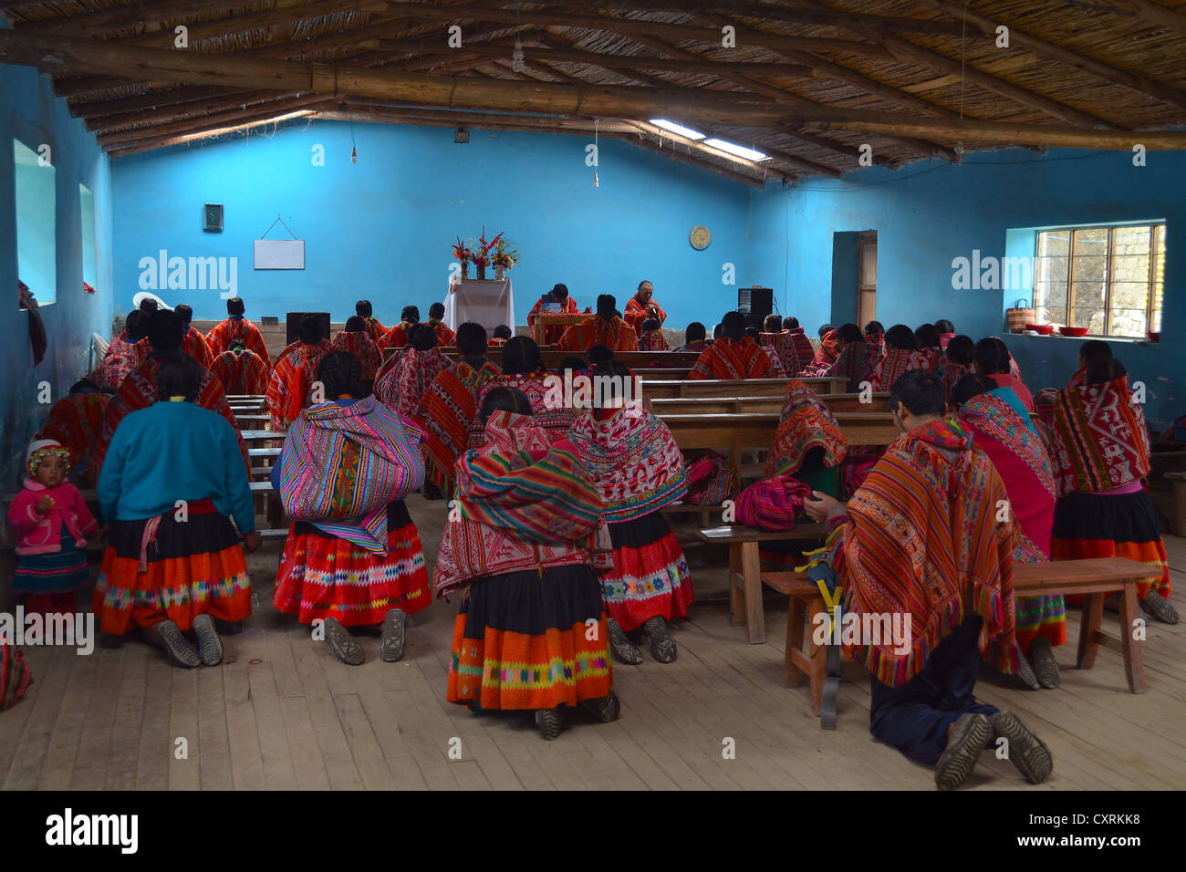 Traditionally dressed Indio community in a small church, Andes Mountains, near Cuzco, Peru, South America Stock Photo