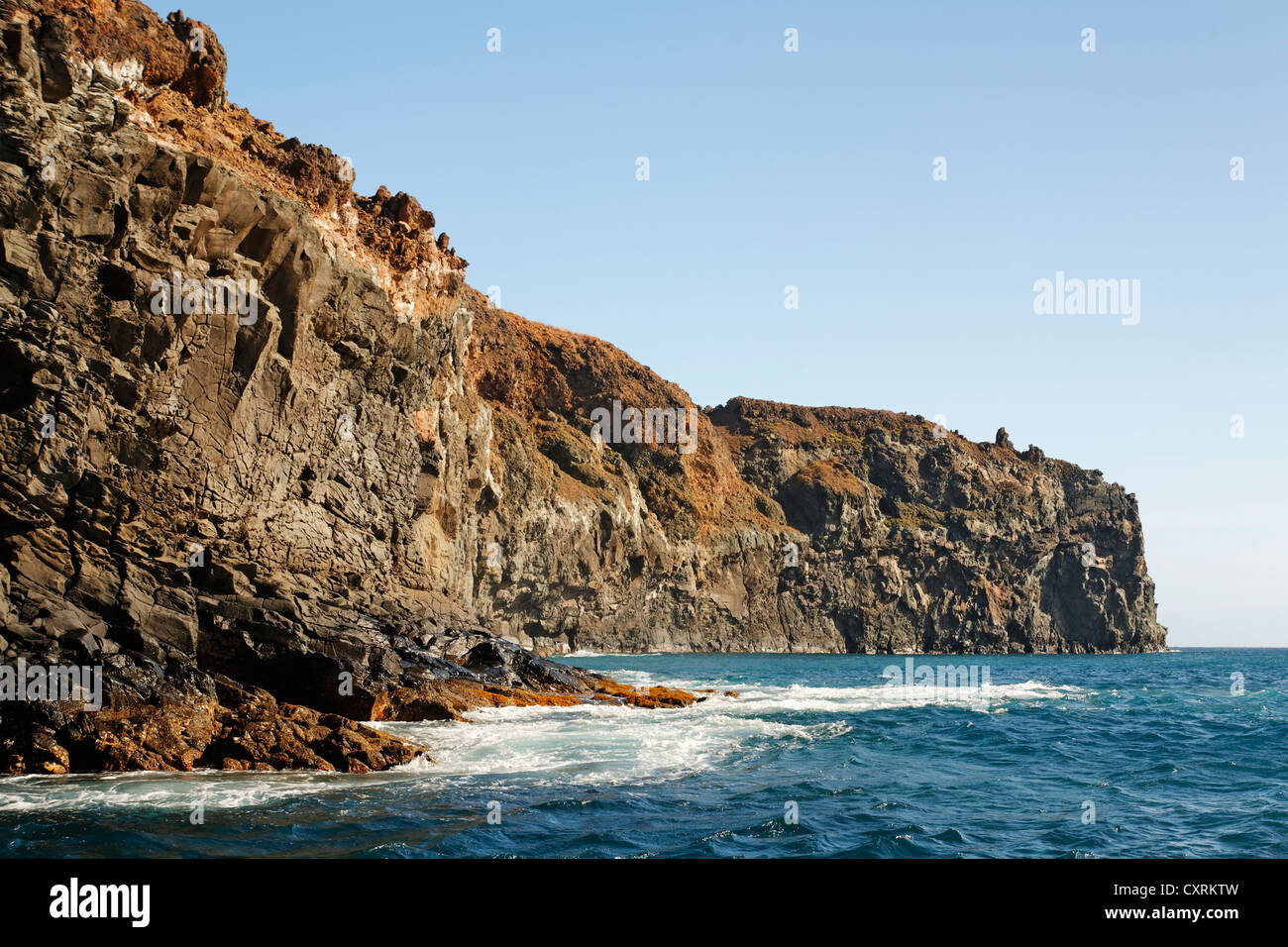 Steep volcanic cliffs, rock layers on the coast, San Benedicto Island