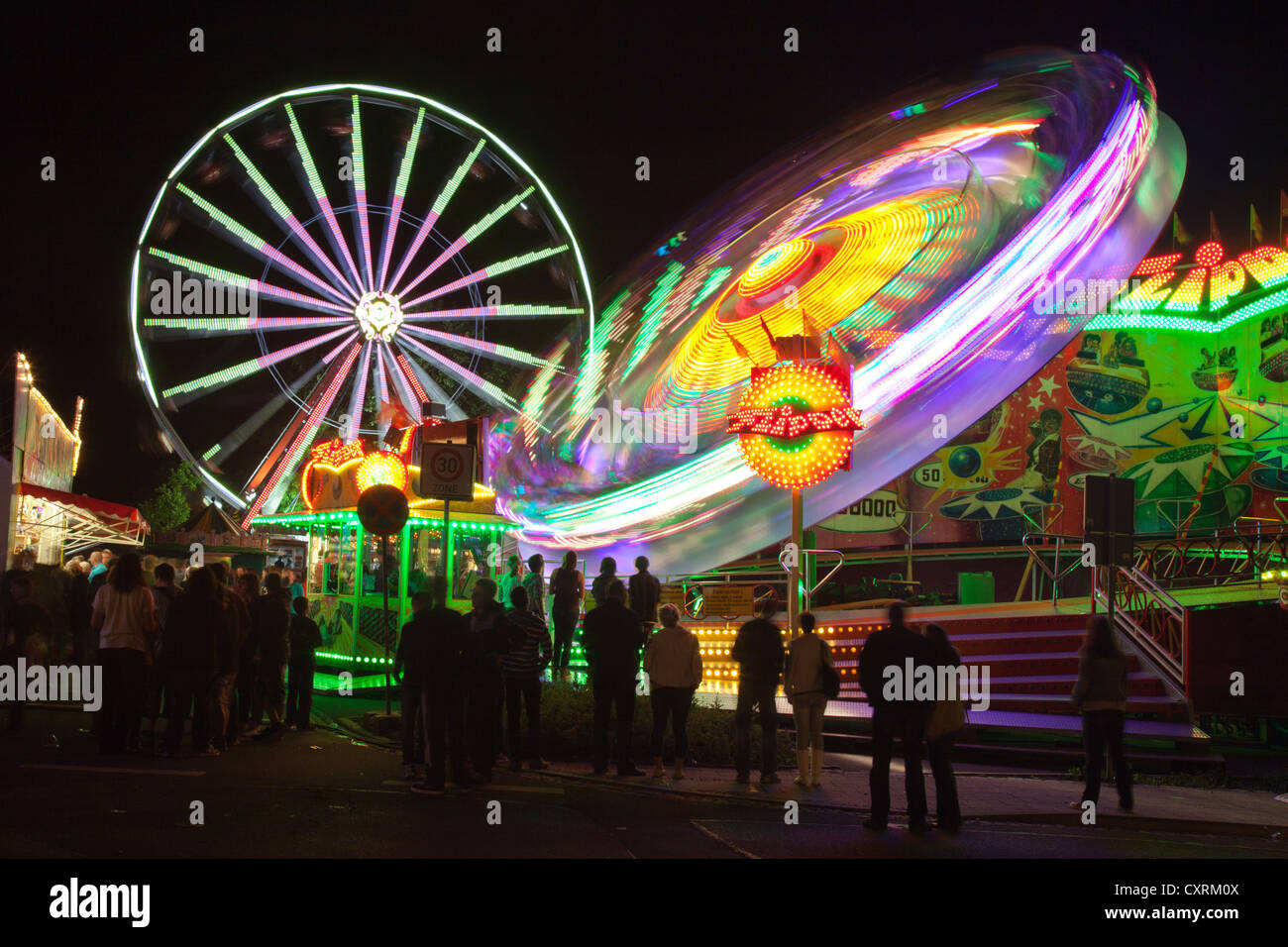 Ferris wheel and flipper at night, town festival 2012, Eilenburg, Saxony, Germany, Europe Stock Photo