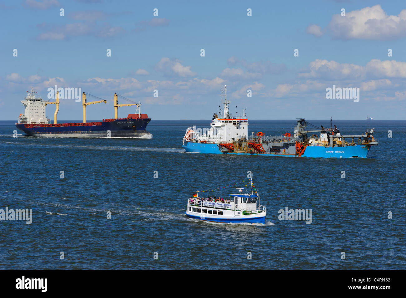 A Container vessel, a suction dredger and a launch passing Cuxhaven, Lower Saxony, Germany, Europe, PublicGround Stock Photo