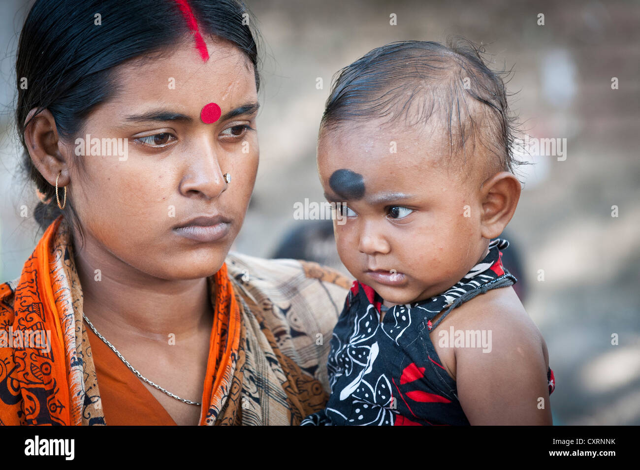 Mother carrying a toddler at a vaccination campaign run by the air organisation "Doctors for the Third World" Stock Photo