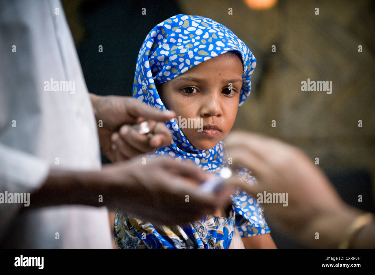 Girl watching preparations for a vaccinations, clinic of the aid organisation 'Aerzte fuer die Dritte Welt', German for 'Doctors Stock Photo