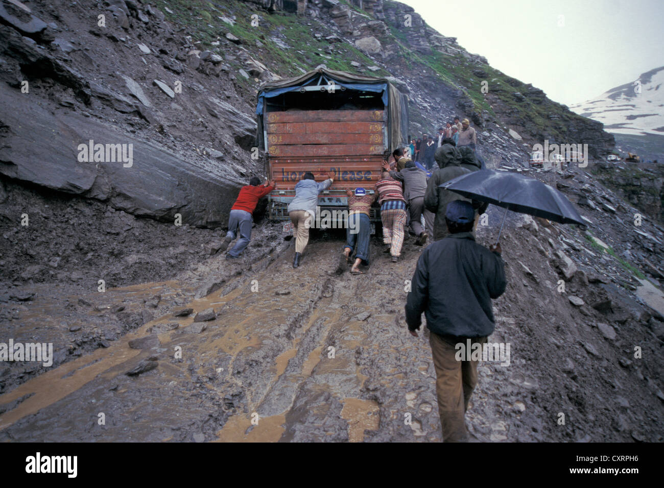 Truck is being pushed, watered down and road vulnerable to landslides, Rohtang Pass, Manali Leh Highway, Himachal Pradesh Stock Photo