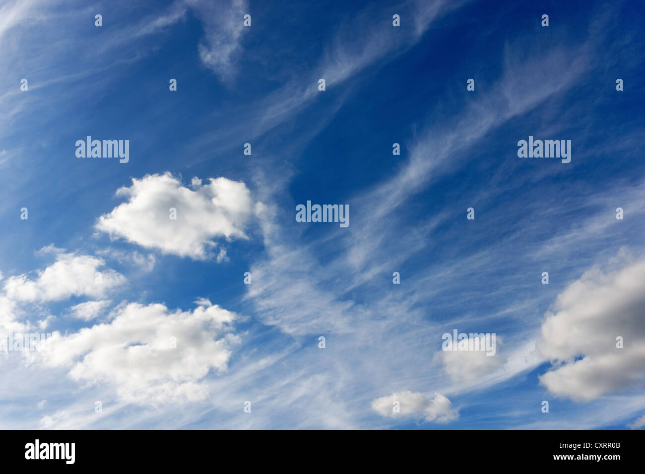 Blue sky and fluffy clouds background Stock Photo - Alamy
