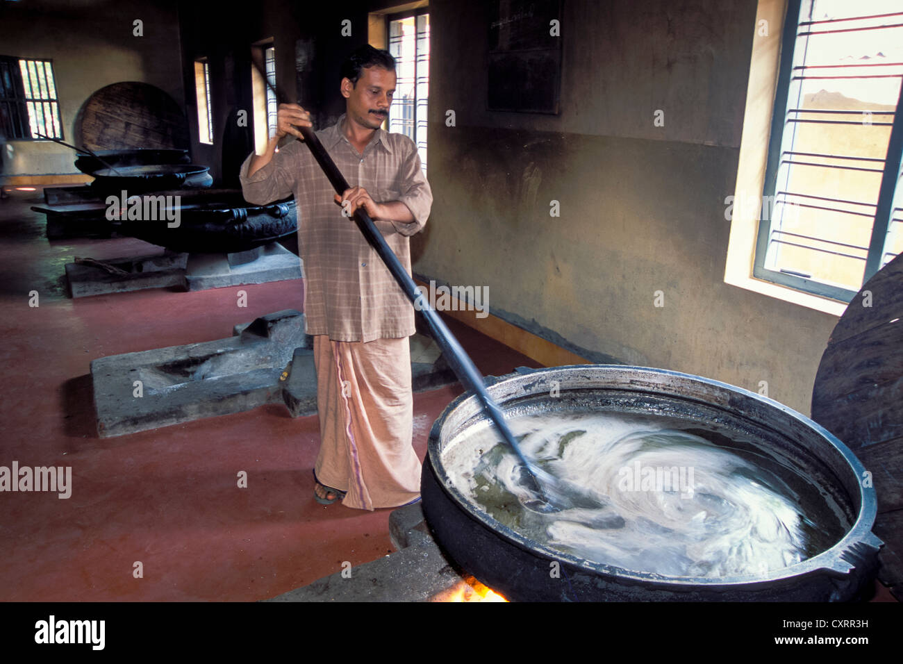 Man mixing ointment, preparation of Ayurvedic medicines, Keraleeya