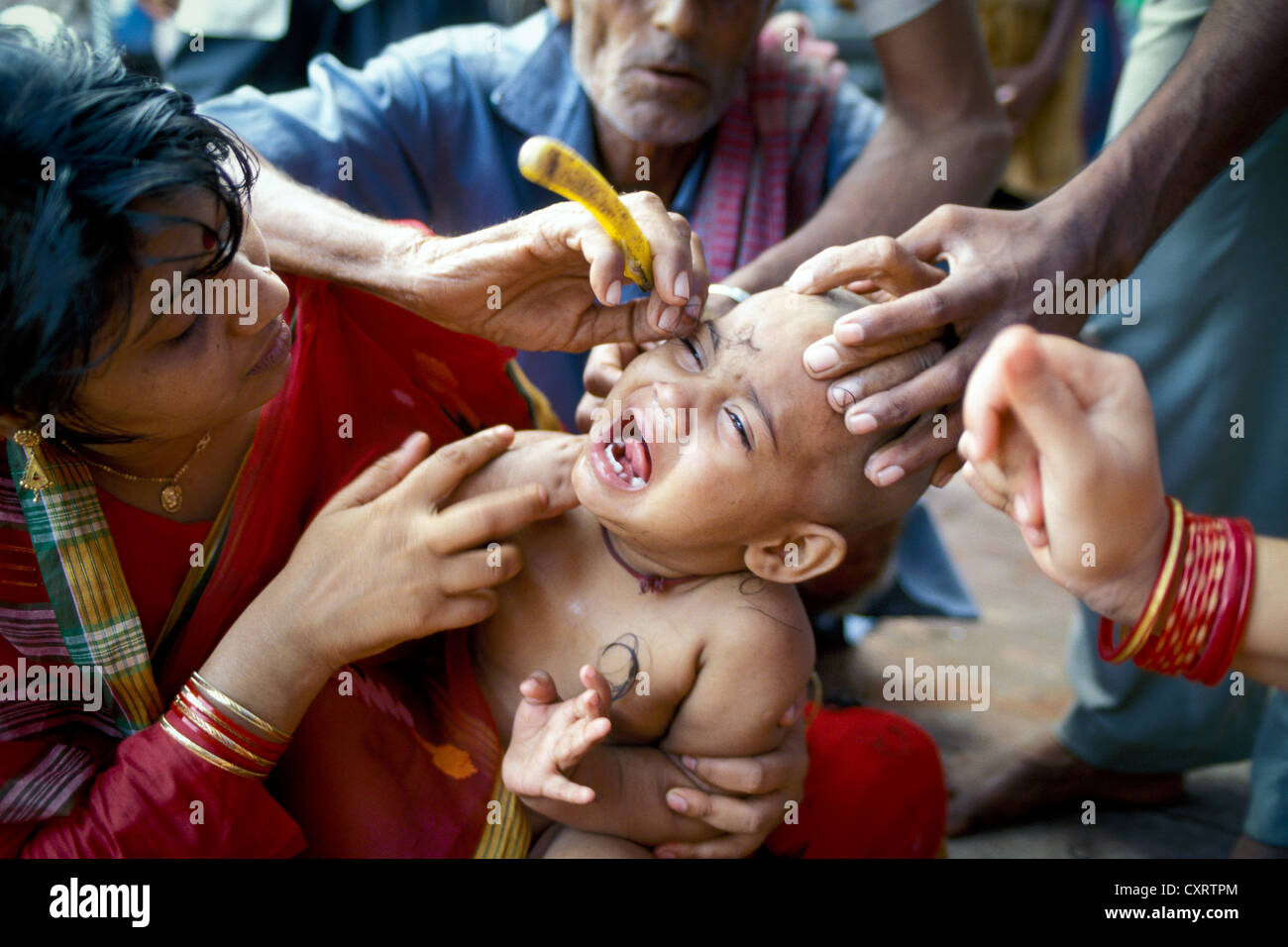 Keshdan ceremony, baby has hair shaved off which is later sacrificed in the temple in front of the Hindu temple fo Jagannath Stock Photo