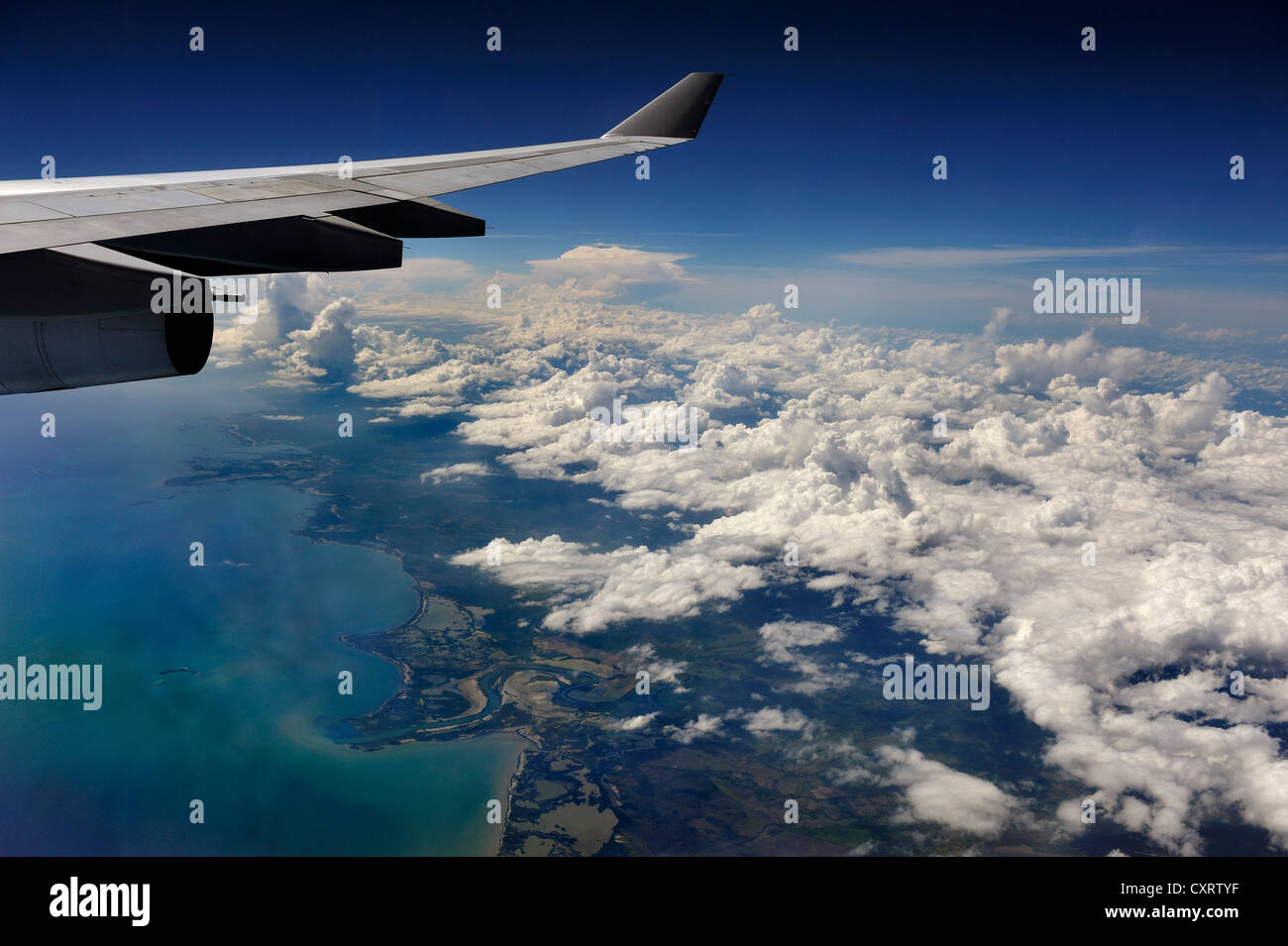 View from an aircraft, clouds and the ocean from above, wing of an airplane, Cuba, Caribbean Stock Photo