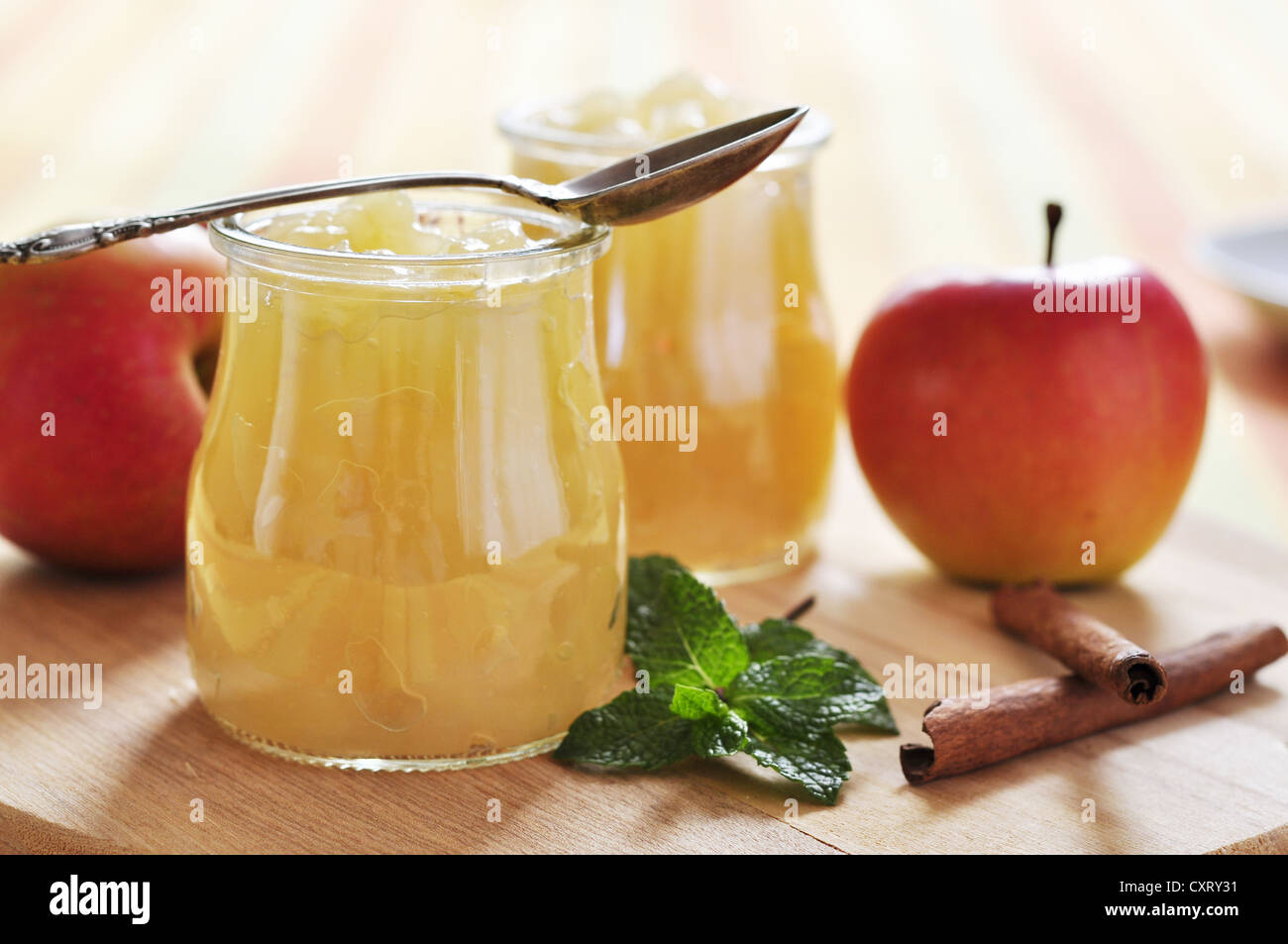 Apple jam with cinnamon and mint on wooden cutting board Stock Photo
