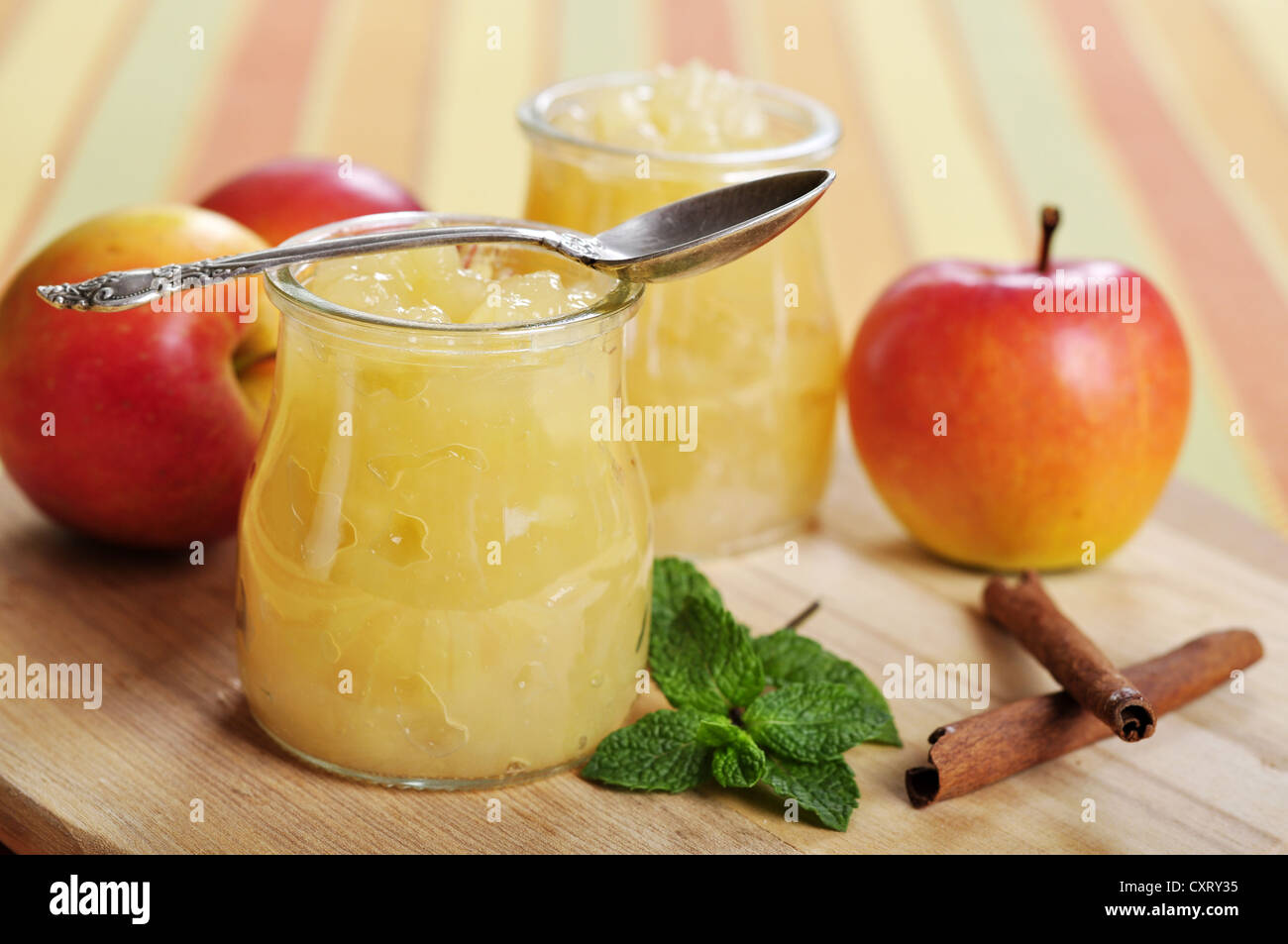 Apple jam with cinnamon and mint on cutting board Stock Photo
