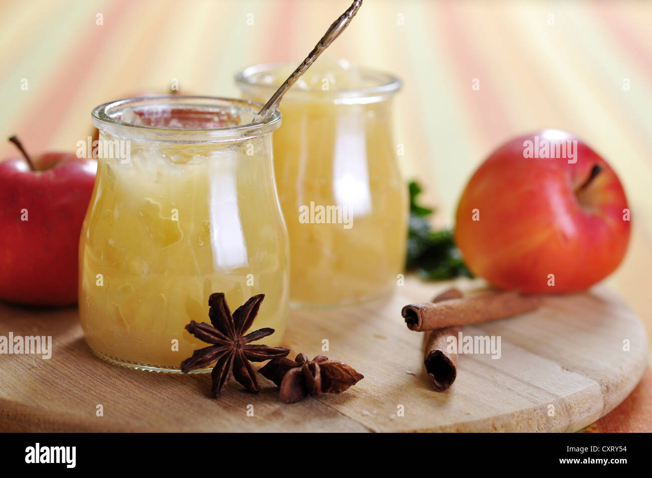 Apple jam with cinnamon on cutting board. Stock Photo
