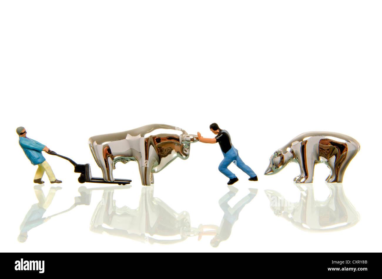 Two workers, miniature figures moving the stock market bull away on a lifting cart, symbolic image for stock exchange Stock Photo