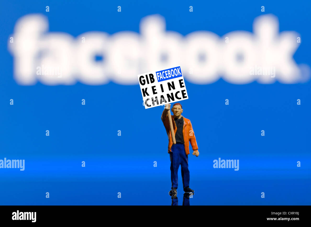 Protester holding a board, lettering 'Gib Facebook keine Chance', German for 'No chance for Facebook', miniature figure standing Stock Photo