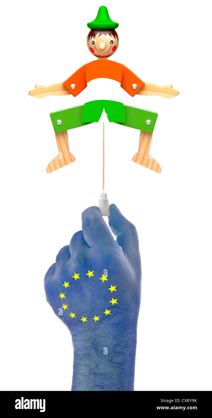 Hand with European stars pulling the rope of a jumping jack in Irish national colors, symbolic image Stock Photo