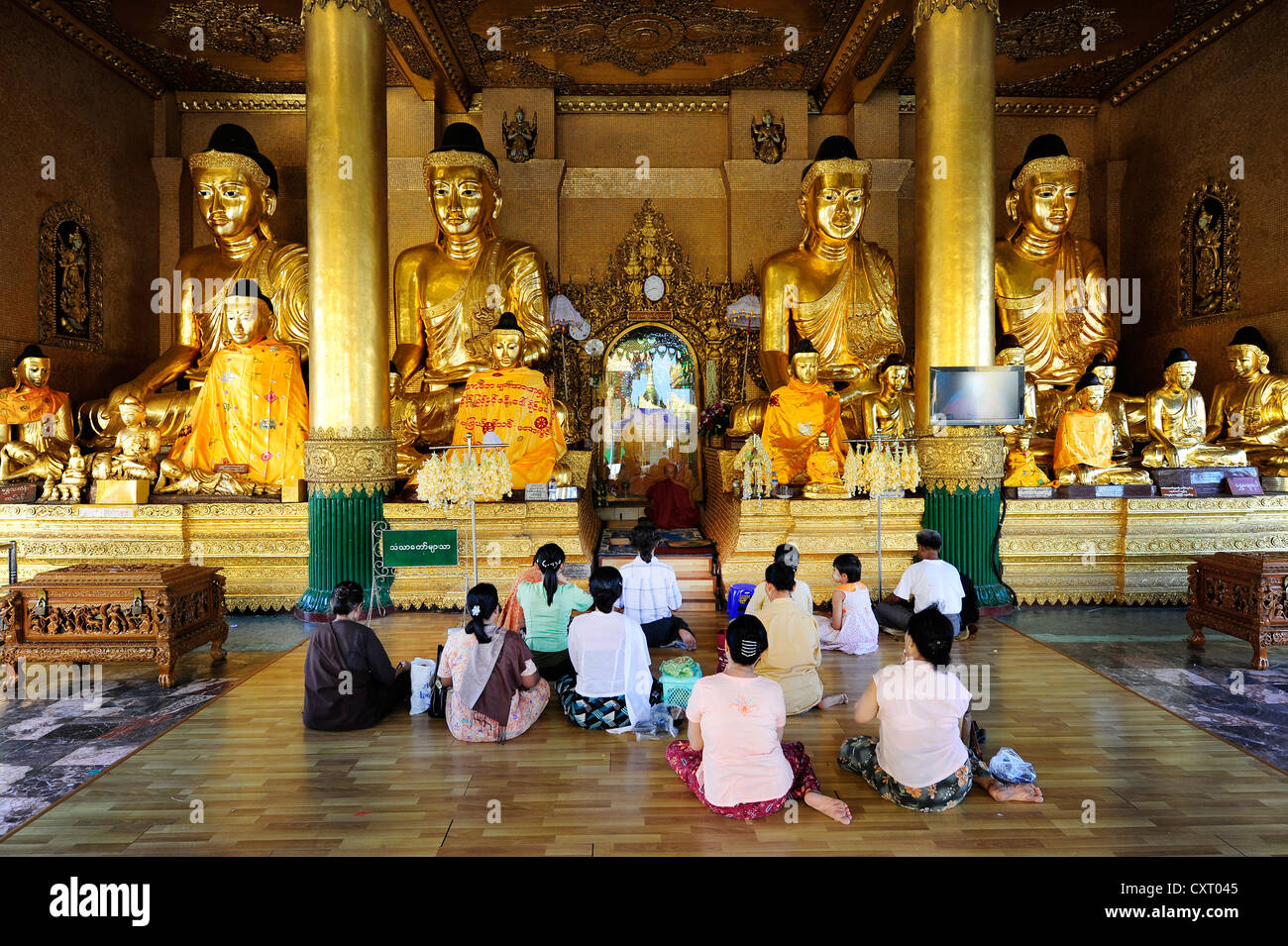 Buddhists praying at the Shwedagon Pagoda, Yangon, Burma also known as Myanmar, Southeast Asia, Asia Stock Photo