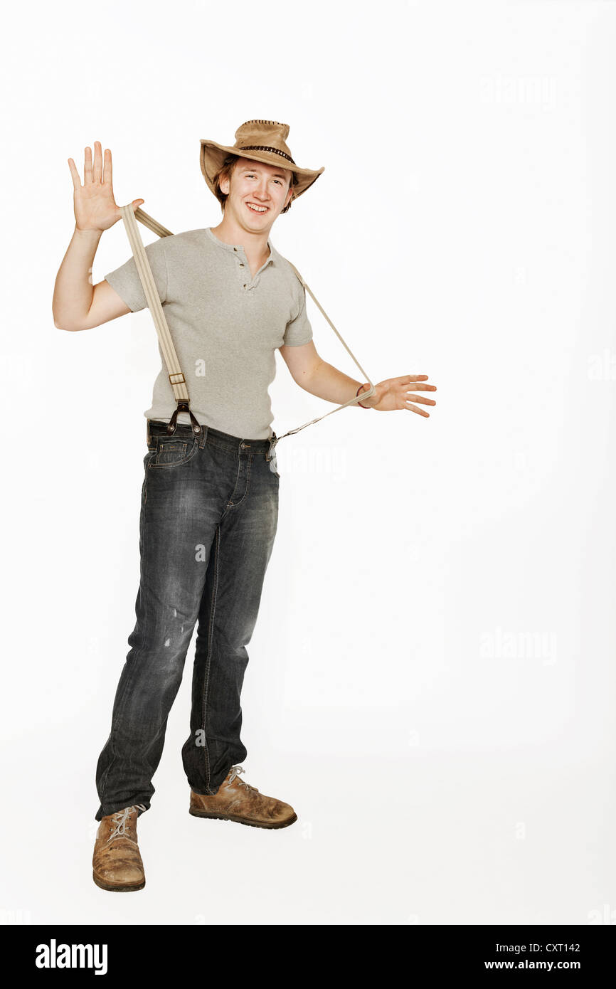 Young organic farmer wearing a leather hat, Austria Stock Photo