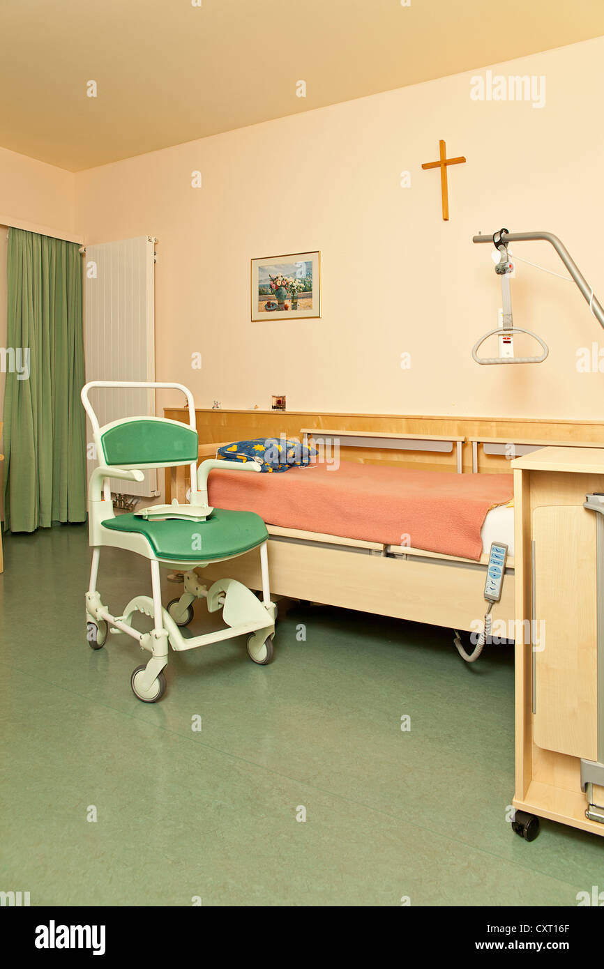 Empty room in a nursing home with a commode Stock Photo