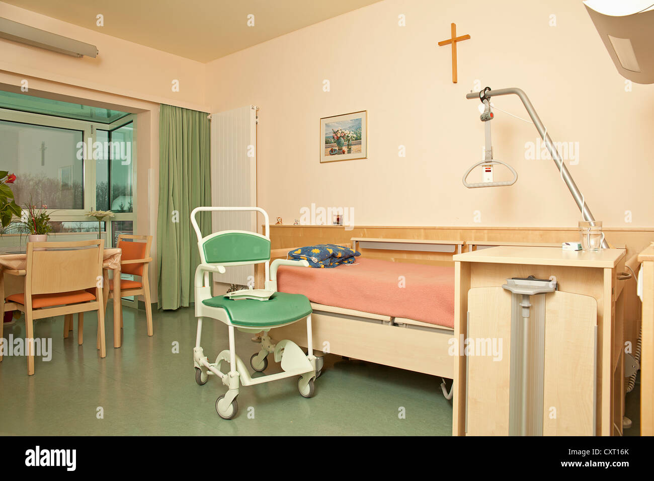 Empty room in a nursing home with a commode Stock Photo
