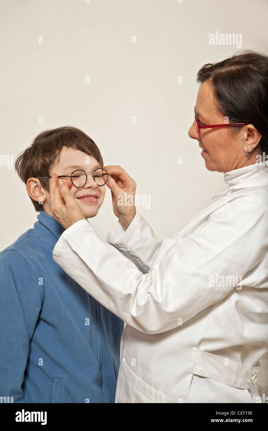 Boy at the eye doctor's, trying on glasses Stock Photo