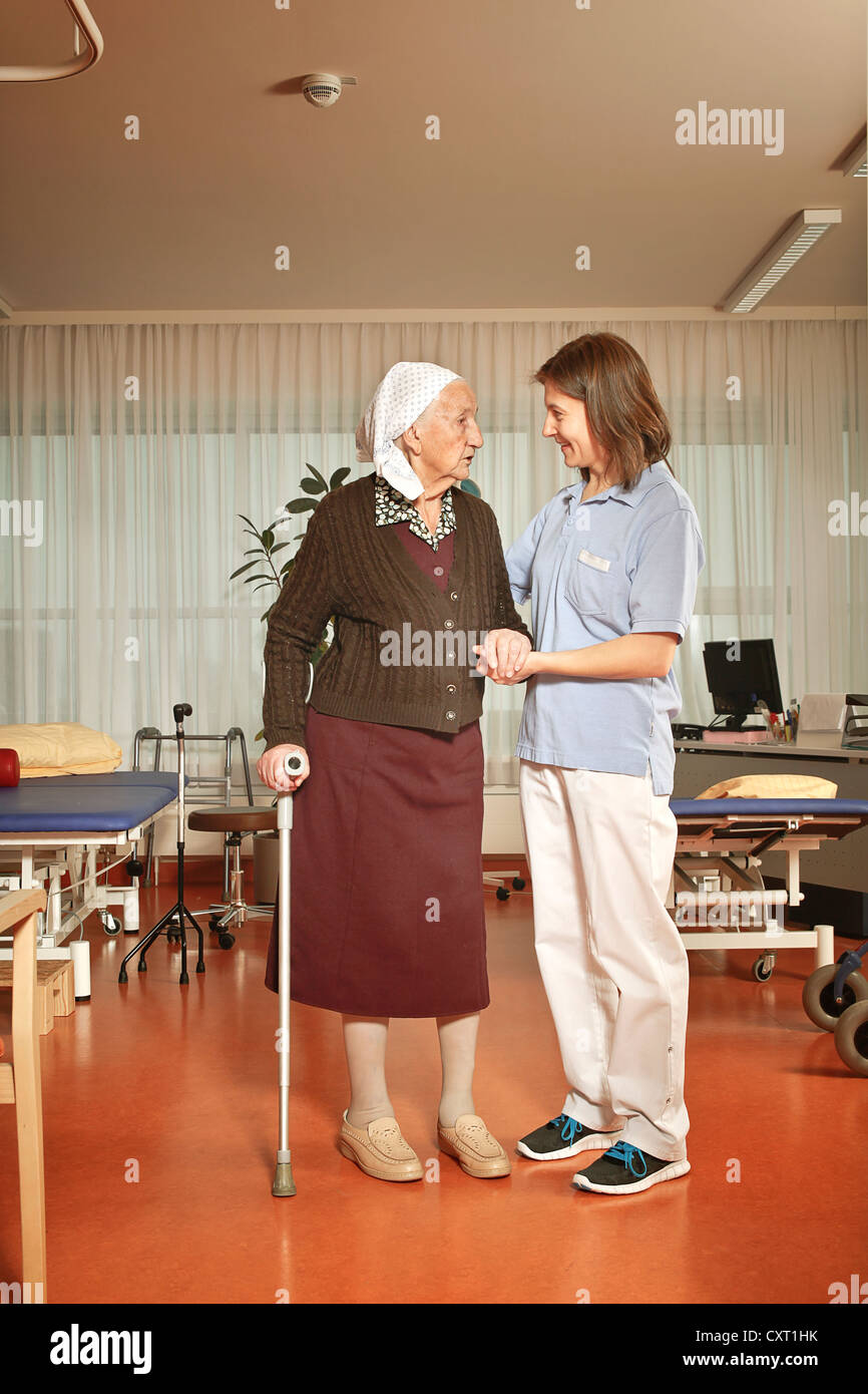 Elderly woman with a nurse during physiotherapy in a nursing home Stock Photo