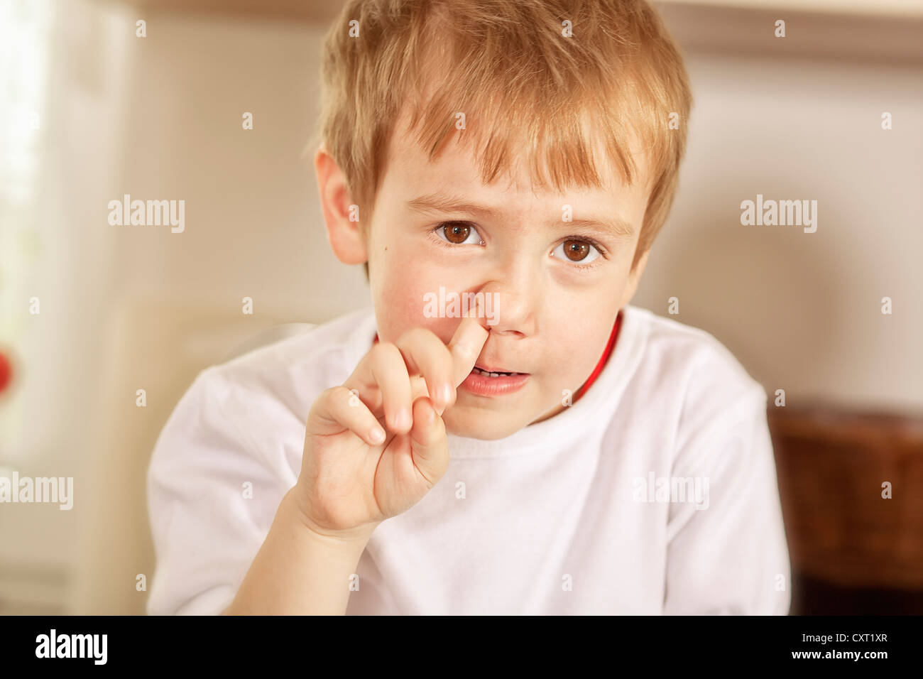 Boy picking his nose Stock Photo