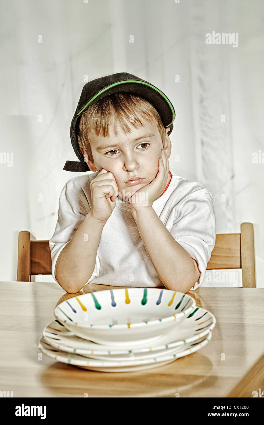 Boy sitting at the dinner table Stock Photo Alamy