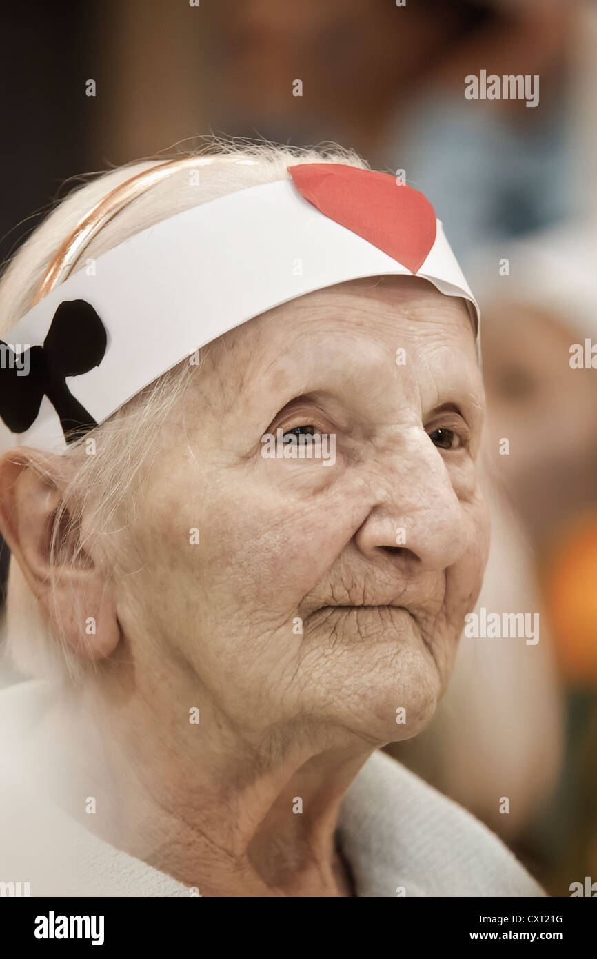 Old woman at a carnival party Stock Photo