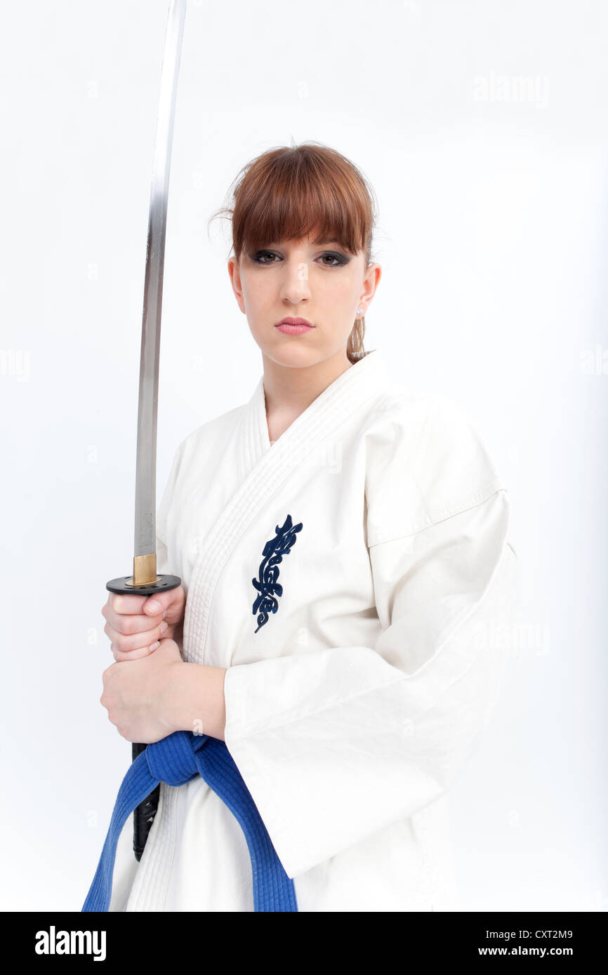 Young woman in a karate suit holding a sword, saber Stock Photo Alamy