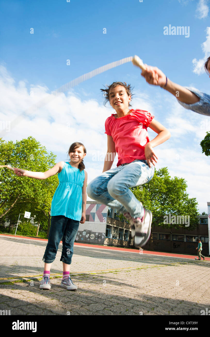 Two girls skipping rope in the school playground Stock Photo Alamy
