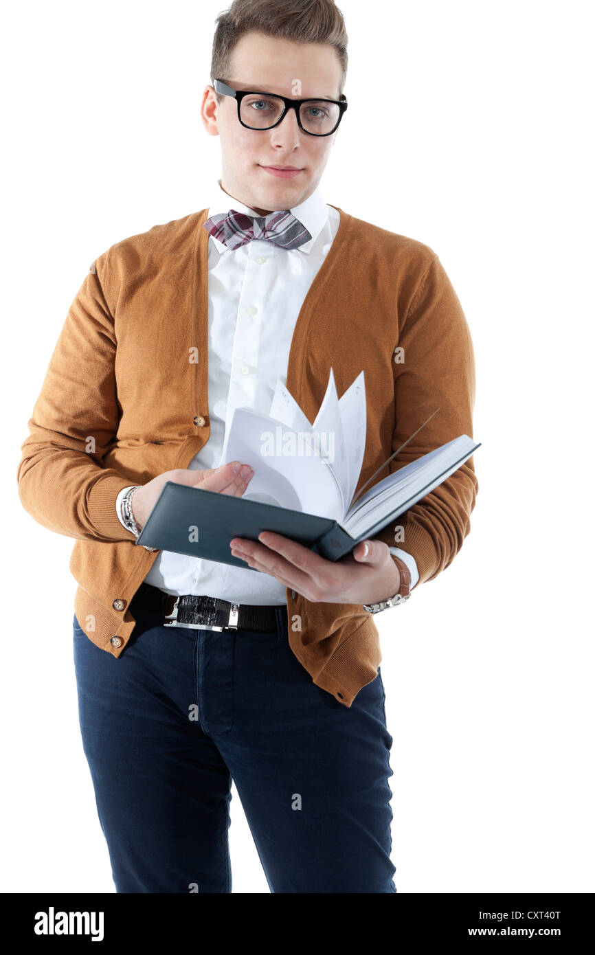 Young man wearing glasses and a bow tie leafing through an appointment diary Stock Photo