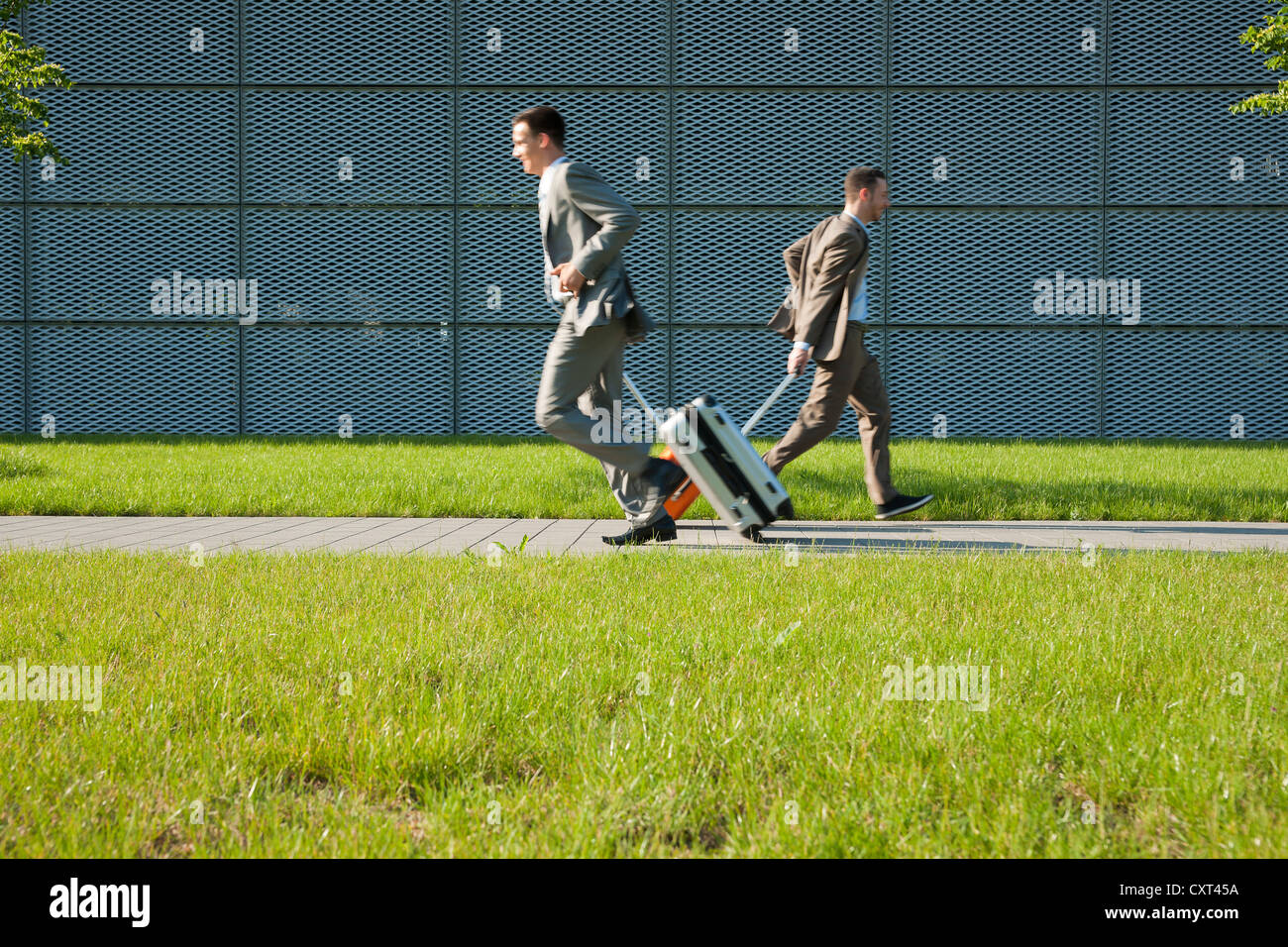 Two businessmen hurrying to an appointment Stock Photo
