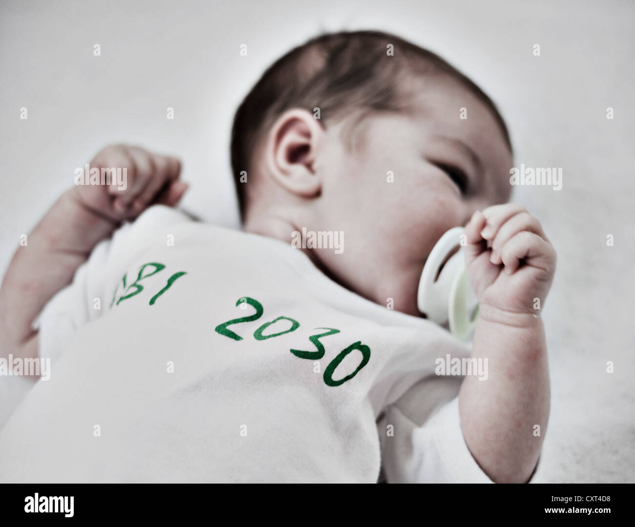 Baby wearing a romper with the lettering ABI 2030 Stock Photo