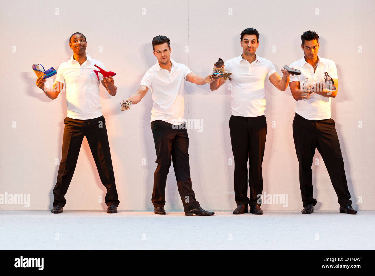 4 young men, models performing in the Spring and Summer Fashion Show 2012 in Pilatusmarkt in Kriens, Lucerne, Switzerland Stock Photo
