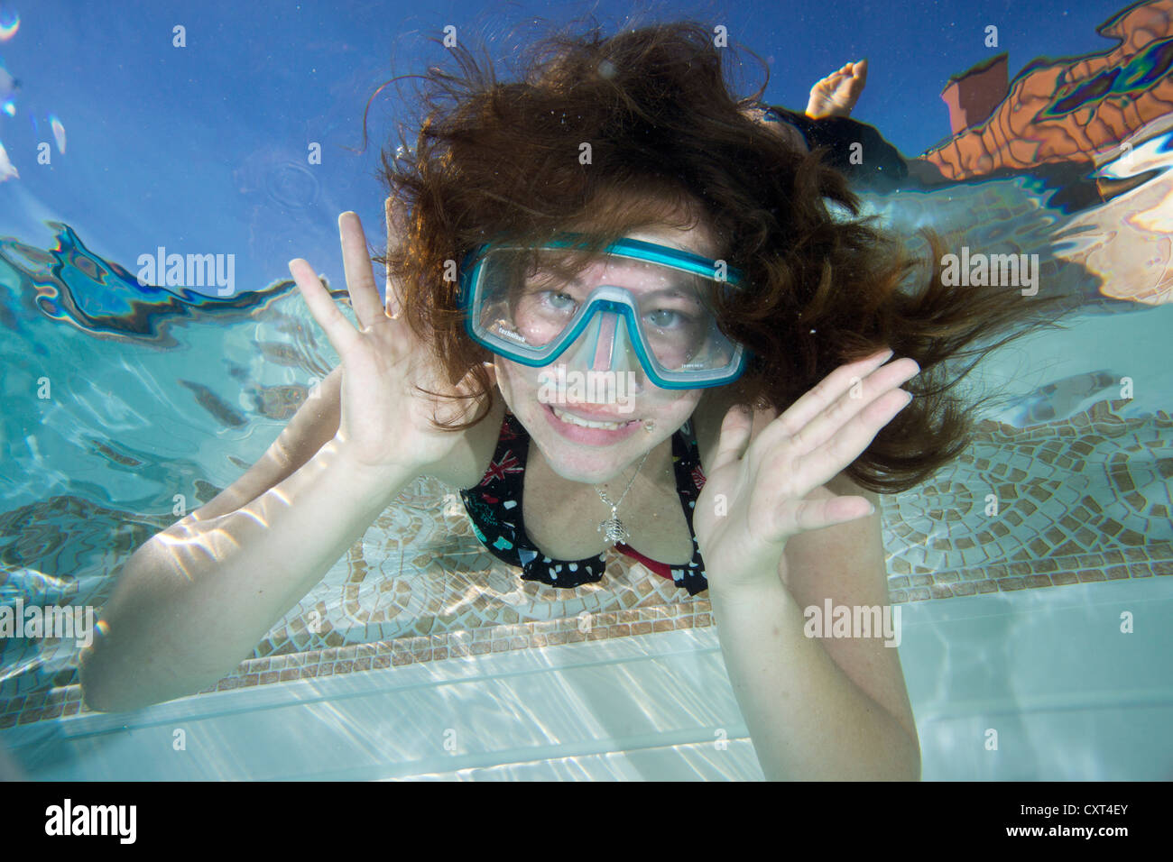 Girl with diving googles underwater in a swimming pool, Germany Stock